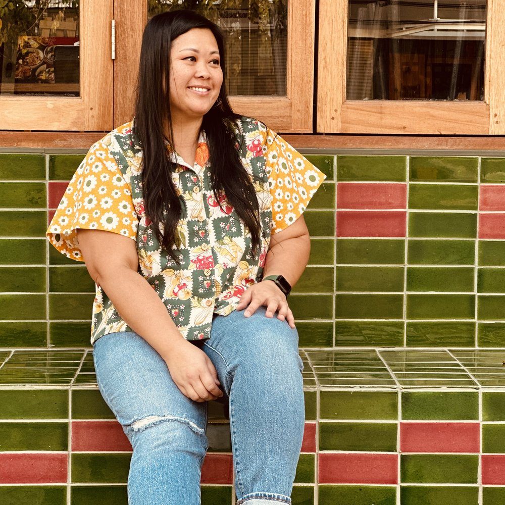 Vanny Deez smiling, wearing a camp shirt sewn from vintage tablecloths